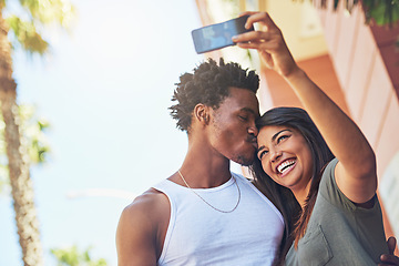 Image showing Selfie, kiss and interracial couple with phone in the city, date and happiness with memory together. 5g technology, love and black man and woman with affection for a mobile photo with a smile