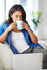 Image showing Woman, laptop and relax on sofa with coffee for morning routine, working online or read social media communications on tech. Drink tea, peace on couch and streaming news or web blog on computer