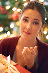 Image showing Christmas, gift and woman pointing at choice or person to give present for Christian religion holiday celebration with a Christmas tree. Portrait of female at home with giftbox for giving background