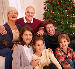 Image showing Christmas, happy and portrait of family on sofa for festive, celebration and holiday cheer. Support, relax and smile with people in living room at home for gift giving, xmas and gratitude together