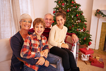 Image showing Christmas, senior couple and couch for grandchildren, happiness or relax for festive season in lounge. Xmas, love or portrait for elderly man, mature woman or grandkids or happy with smile or content