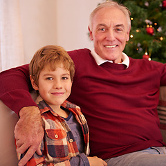 Image showing Elderly man, grandson and christmas portrait on sofa with love, bonding or happiness in family home. Boy, grandfather and smile together for celebration, holiday or happy on couch in house by tree