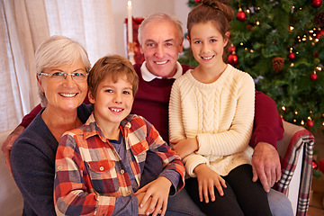 Image showing Christmas, senior couple and couch with grandchildren, happiness and relax for festive season at home. Xmas, love and elderly man with mature woman, grandkids or happy with smile, content or portrait