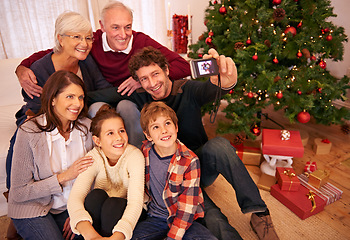 Image showing Family, christmas party and phone selfie, festive season or holiday celebration. Portrait, smile and grandparents, kids and parents celebrate, picture pose or photo smile for memory together in home