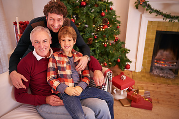 Image showing Portrait of a grandfather, father and child at a christmas event relaxing on sofa together. Happy, smile and senior man in retirement sitting with dad and boy kid at festive xmas celebration at home.