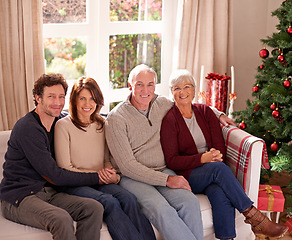 Image showing Christmas, family and together on sofa for portrait in living room to celebrate festive holiday. Quality time, relax and happy family relax for bonding, support and care on couch for celebration