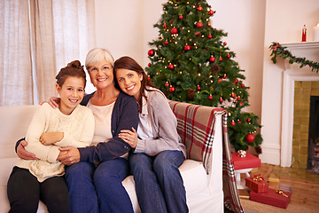 Image showing Christmas, portrait and family on sofa by mother, girl and grandma in celebration of bonding tradition in their home. Happy family, generations and women embrace in living room for festive vacation