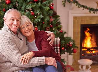 Image showing Love, portrait and senior couple at a christmas party or celebration relaxing in the living room of their home. Happy, smile and elderly man and woman embracing at a festive xmas event at a house.