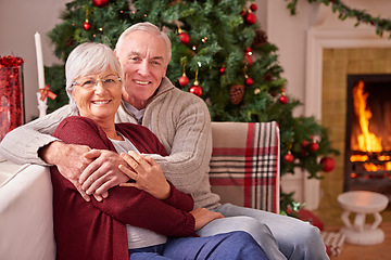 Image showing Christmas, senior couple and on couch together for happiness, festive season and relax at home. Xmas, love and elderly man with mature woman, happy or smile for bonding, content and on sofa in lounge