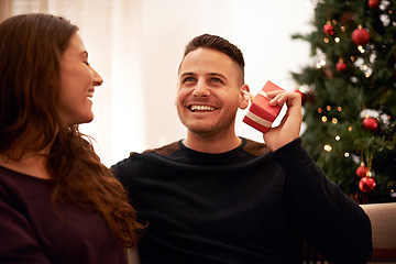 Image showing Couple, Christmas and love with guess gift box for surprise, happiness and holiday excitement. Happy, marriage and present for partner guessing what is inside with cheerful smile in home.