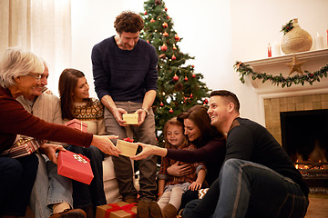 Image showing Family, christmas and holiday gift event of mother, dad and children with grandparents happy. Party and celebration event of people giving present box with thank you and gratitude on holiday at home