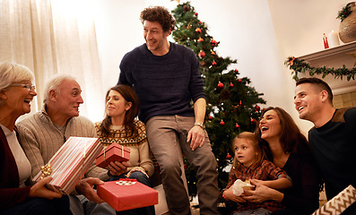 Image showing Christmas, family and gift for happiness, joy and bonding together with smile, laugh and talking. Xmas, grandparents and siblings talking, presents and celebration for holiday, vacation and festive.