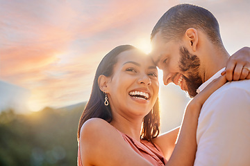 Image showing Sunset, romance and love with a couple hugging outdoor while happy dating in nature together. Sky, mockup and date with a young man and woman embracing while romantic bonding outside in summer