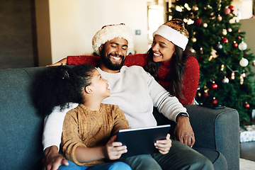 Image showing Christmas, family and tablet on sofa in home streaming movie or internet browsing. Xmas, love and girl, father and mother with digital touchscreen bonding, caring and enjoying holiday time together.