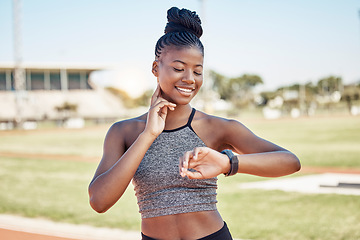 Image showing Fitness, smartwatch and heart rate with black woman running on stadium track for training, sprinting or stamina endurance. Goals, tracker and progress app with runner checking time for cardio workout