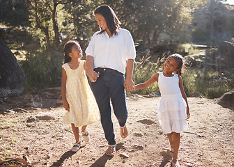 Image showing Mother and children holding hands while walking in nature on adventure, hiking or family bonding trip on mothers day. Woman outdoor at park for travel with daughters or girl kids for love and support