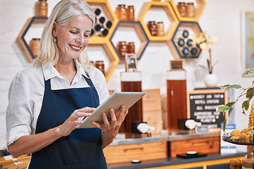 Image showing Happy small business owner, tablet or senior woman in honey retail store for research, communication or networking. Smile, honey or manager with social media app update, online store or order review