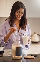 Image showing Woman, smile and morning making coffee in the kitchen for routine, start or daily preparation at home. Female smiling and adding sugar to mug for sweet warm beverage drink or caffeine at the house