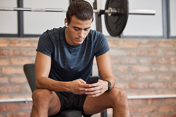 Image showing Fitness, relax and phone with man in gym for training, workout or exercise. Social media, internet and music with bodybuilder athlete and mobile for health, wellness or performance in sport club