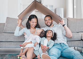 Image showing Family, children and insurance with a mother, father and daughter siblings in a living room of their home together. Security, safety and homeowner with parents holding cardboard to cover sister kids