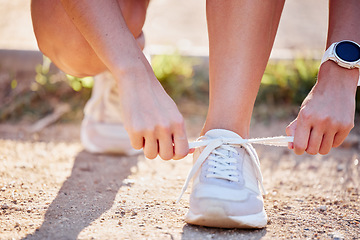 Image showing Shoes, running and fitness person hands in nature tie laces to start a run, hike or walk. Exercise, training and running workout of an athlete ready for outdoor travel walking for health and sport