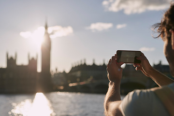 Image showing Man photograph Big Ben on phone in London, traveling and tourism, holiday sightseeing and famous historic landmark, buildings and vacation. Tourist, mobile pictures and clock tower in England city