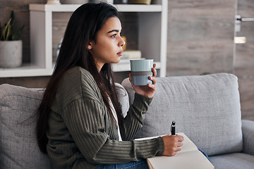 Image showing Relax, thinking and woman journaling with coffee for self care on the living room sofa of her house. Idea, tea and girl with creativity in a notebook, green tea and writing in diary on the couch