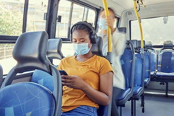 Image showing Bus, travel and covid woman on a phone and headphones for corona virus update, listening to news and social media report on journey. Girl covid 19 face mask, technology and transport rules for safety