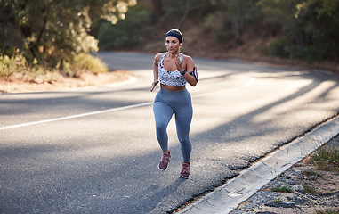 Image showing Wellness, nature or woman running on mountain street for marathon training, cardio fitness or workout. Motivation, sports or girl runner from Canada for road exercise, health or triathlon outdoor