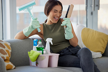 Image showing Cleaning, housework and woman singing on sofa with smile, detergent and happy excited for chores in living room. Home maintenance, girl in clean and fresh house, housekeeping and spring clean work.