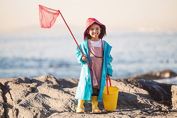 Image showing Child, kid or girl portrait with fishing bucket and net at beach, ocean or sea to fish in summer. Happy black child outdoor learning for salt water shrimp, crabs or fish with smile in holiday