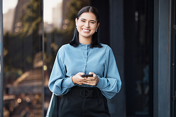 Image showing Phone, portrait and happy with a business woman typing a text message while standing outdoor on an office balcony. Social media, smile and communication with a female employee sending a mobile email