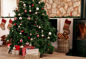 Image showing Christmas tree, present and holiday living room in winter with house decoration and gifts. Home gift giving and celebrating tradition with trees in the morning ready for a festive party in household