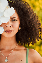 Image showing Black woman, beauty and orchid flower outdoor in nature for cosmetic, makeup and natural dermatology product. Face of aesthetic model with natural plant skincare, health and fashion vacation portrait