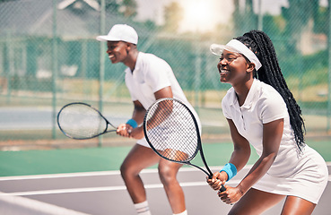 Image showing Tennis, sports and competition with a black woman and doubles partner playing a game on a court outdoor together. Fitness, team and exercise with a man and female tennis player at a venue for sport