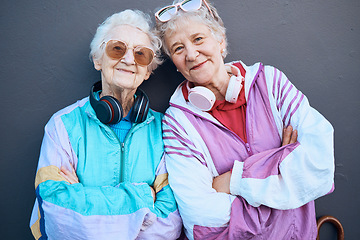 Image showing Portrait, fashion and friends with a senior woman pair standing arms crossed outdoor on a gray wall background. Retirement, happy and bonding with a mature female and friend posing for funky style