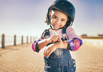 Image showing Skating injury, first aid or child portrait with bandage bruise from skate, cycling or accident in street. Happy, smile or girl with helmet for exercise, wellness health at beach, sea or ocean