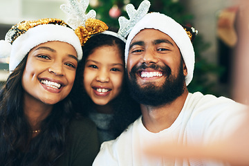 Image showing Family, Christmas selfie and festive holiday celebration, portrait and face in home, hat and decoration together. Mother, father and girl with picture for social media, xmas event and hat in house