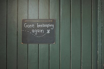 Image showing Door, sign and beekeeping with a chalkboard hanging on an entrance way of a small business in agriculture. Wood, store and retail with a notice on a wooden surface for farming or sustainability