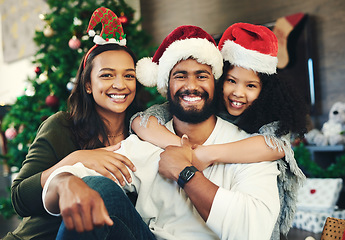 Image showing Christmas, happy and portrait of family in living room for celebration, affection and festive. Holiday, smile and bonding with girl hug parents at home for content, gratitude and xmas vacation