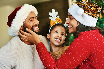 Image showing Family, christmas celebration and love with happy smile and festive holiday, care. and decoration with hat in home. Mother, father and girl together in house to celebrate xmas event in family home