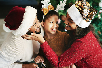 Image showing Black family, happy and celebrate Christmas holiday together for love, support and care. Happiness, parents and child smile for festive celebration vacation at home with christmas tree in living room