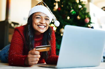 Image showing Woman, christmas and online shopping, credit card and laptop for payment, buy and portrait on festive holiday in home. Xmas, happiness and portrait of female and internet banking, tech and ecommerce