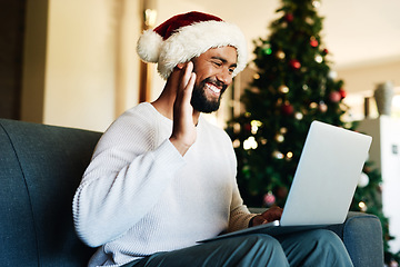 Image showing Man, laptop and video call, wave and christmas celebration in home, virtual conversation or communication in home. Young male, happy smile and hand gesture with video conference , internet or webinar