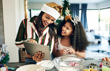 Image showing Family, baking and tablet for christmas cookies, cooking or cake with mother and daughter together while learning online recipe in kitchen, Black woman and child making food to celebrate holiday