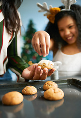 Image showing Hands, cookies and baking with a mother and daughter in the kitchen on Christmas for the festive season. Family, children and food with a woman and girl learning hoe to bake together at home