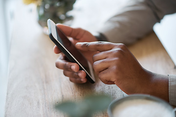 Image showing Hand, table and phone with a man browsing the internet online ot texting a mobile contact while relaxing. Hands, cellphone and african american male scrolling social media or searching for wifi meme