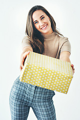 Image showing Portrait, studio and woman giving gift isolated on a gray background. Happy, smile and young female from Canada holding box of presents for Christmas party, new year celebration or birthday event.