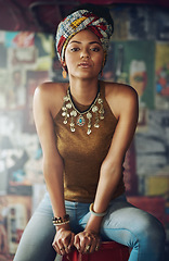 Image showing Portrait, fashion and heritage with a black woman on a stool indoors with an African style turban. Model, culture and tradition with an attractive young female feeling empowerment or proud