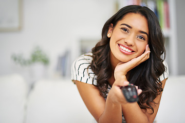 Image showing Movie, happy and woman watching tv to relax with freedom on a weekend a home with an online subscription. Smile, television and excited young girl enjoys streaming a tv show, film or movies on remote